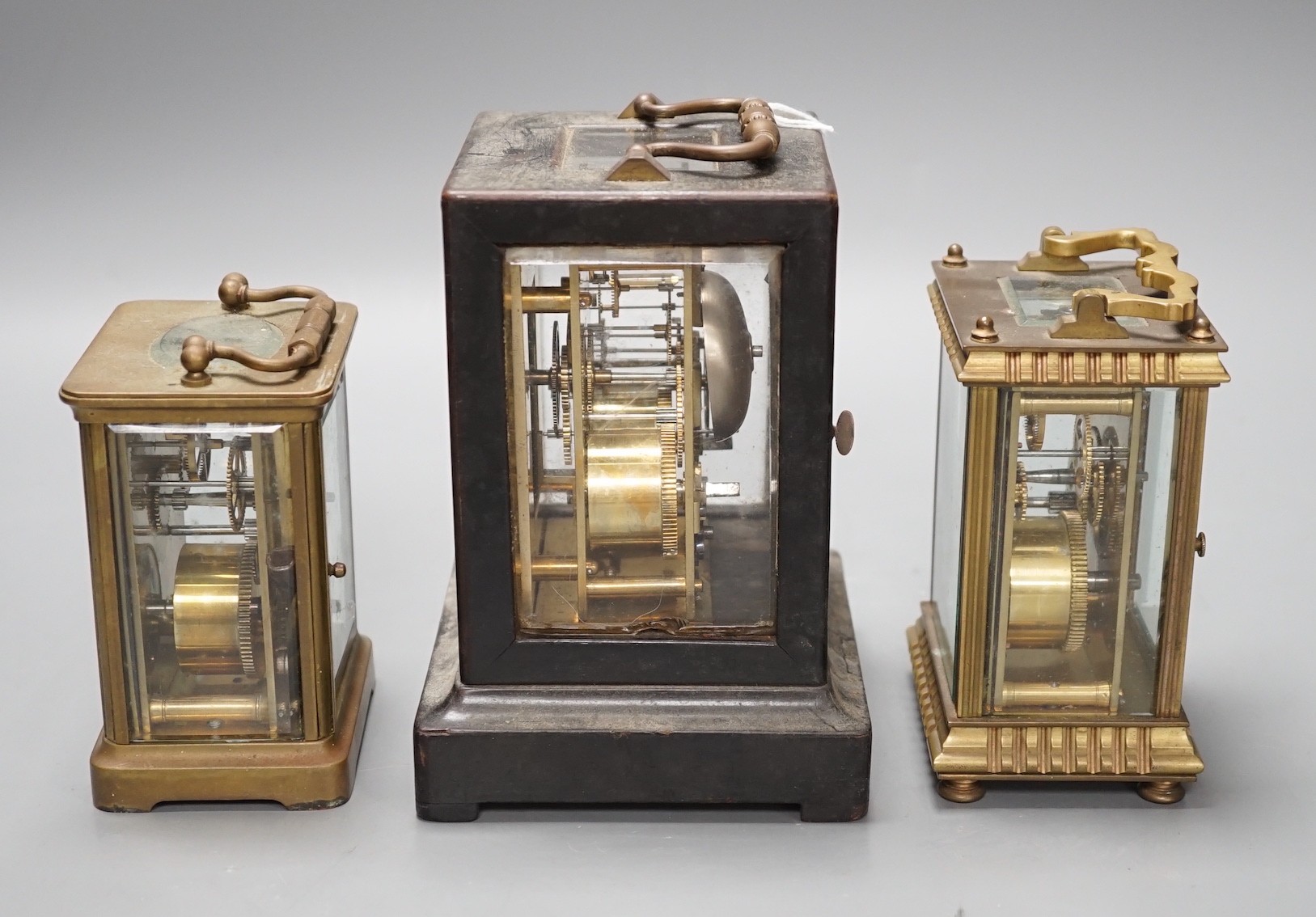 A mid 19th century French ebony veneered carriage clock, 16cm high with J. Cramp Horsham retailers label, a Mappin and Webb carriage clock, another by Mann of Gloucester, tallest 15cms high